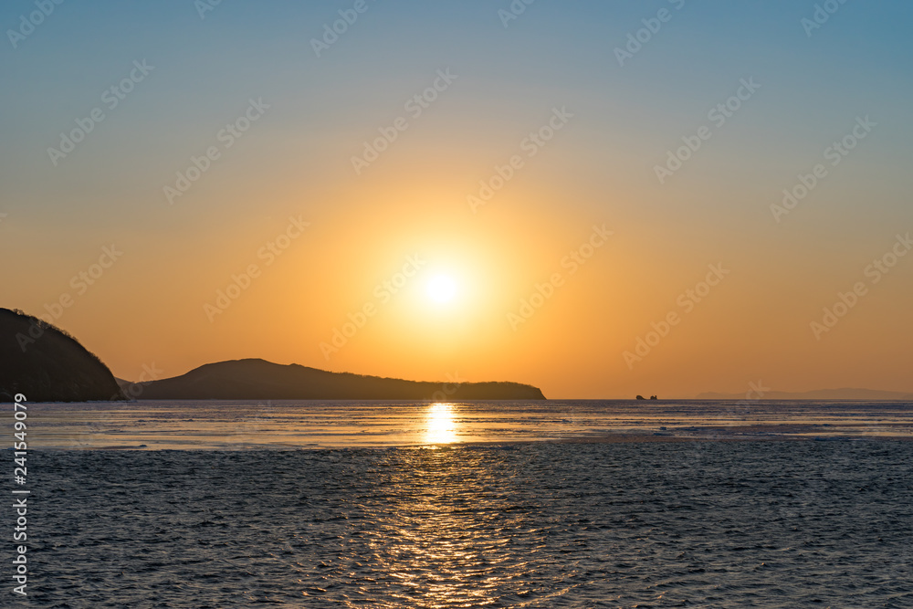 Winter seascape with ice floes on the water surface.