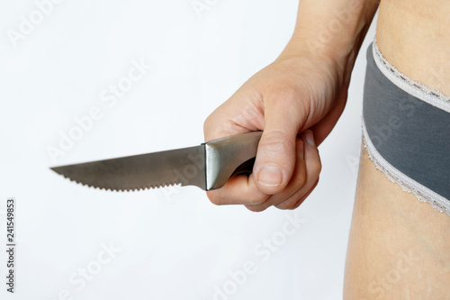 Принти на полотні Female hand holds knife on white background