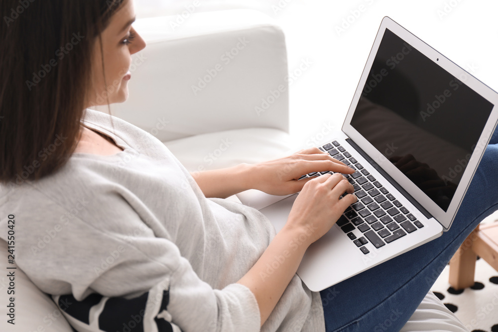 Young woman working with laptop at home Young woman working with laptop at home