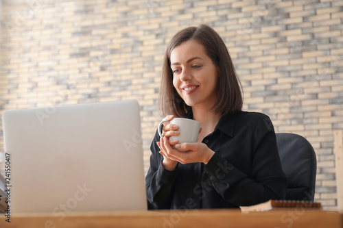 Young woman drinking coffee...