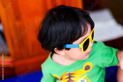 Asian Child baby boy wearing yellow sunglasses