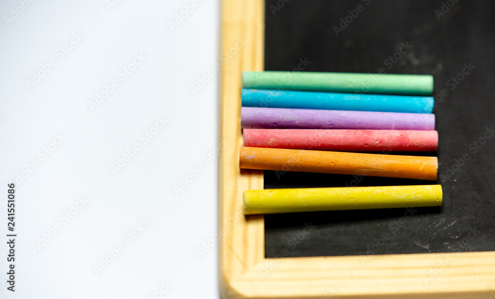 chalk in rainbow colors on a black board chalk in rainbow colors on a black board