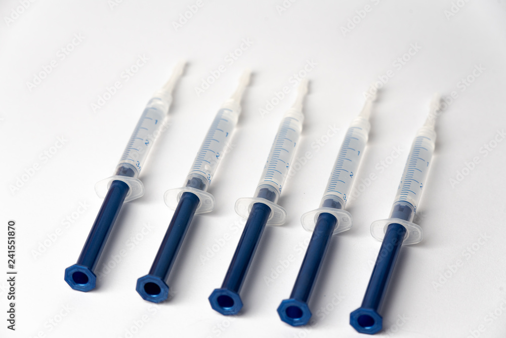 Syringe filled with liquid on a white background Syringe filled with liquid on a white background