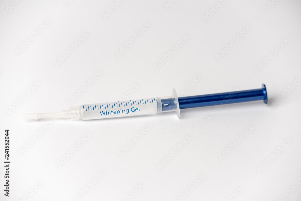 Syringe with teeth whitening liquid isolated on a white background Syringe with teeth whitening liquid isolated on a white background