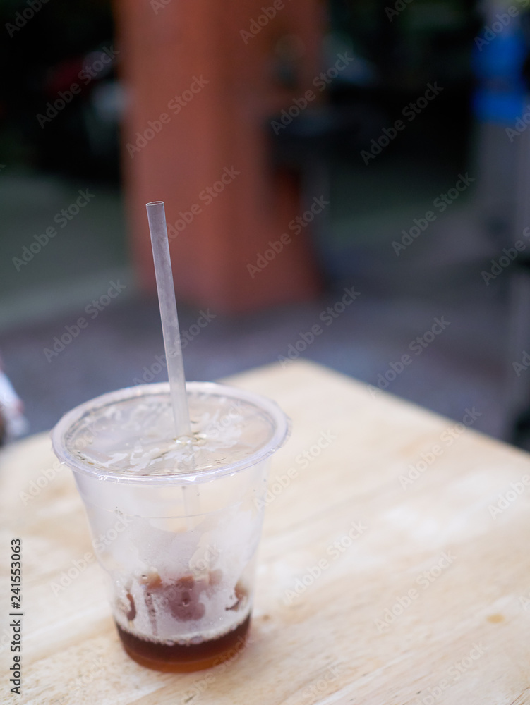 Street food at night - almost empty plastic cup Street food at night - almost empty plastic cup