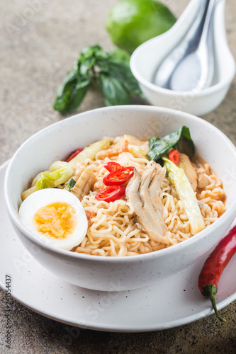 japanese ramen noodle with chicken, shiitake mushroms and egg in white bowl