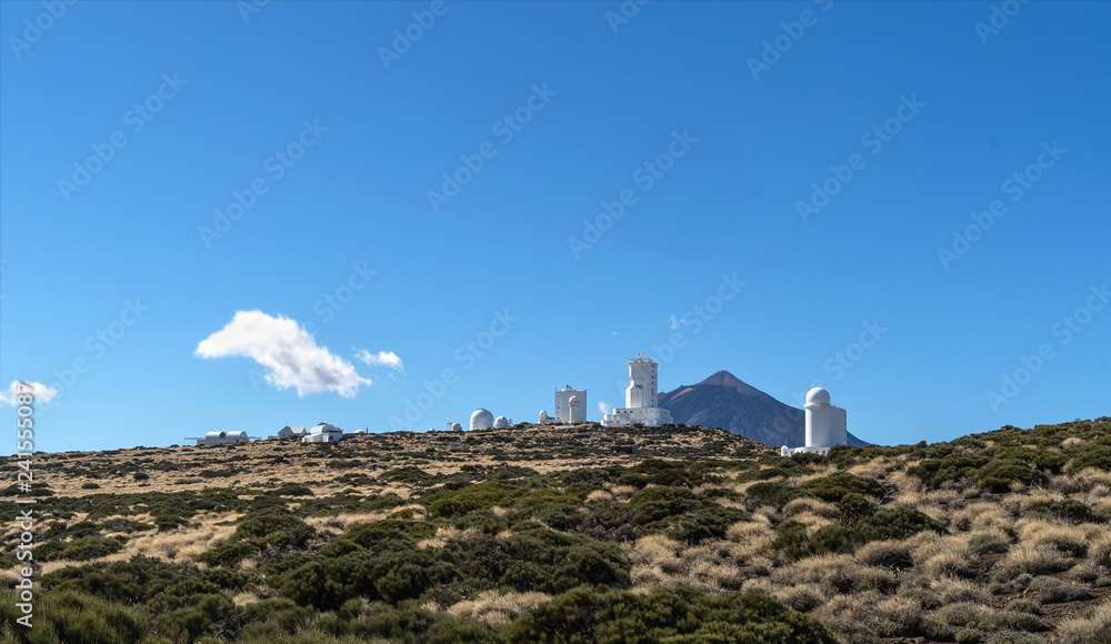 Landscape with sun observatory on the mountains with Teide volcano behind.