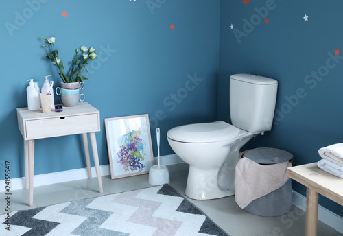 Modern interior of restroom with ceramic toilet bowl