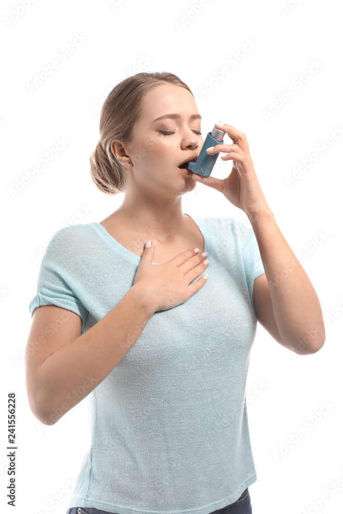 Young woman with inhaler having asthma attack on white background Young woman with inhaler having asthma attack on white background