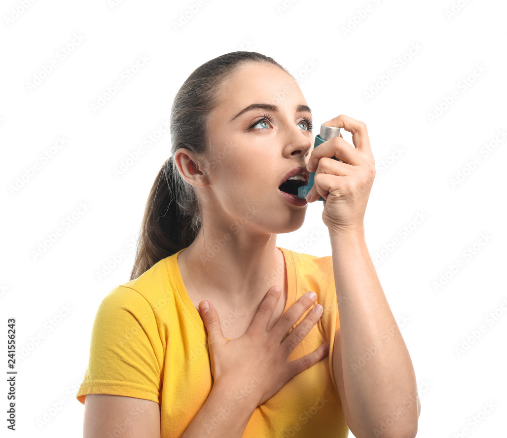 Young woman with inhaler having asthma attack on white background Young woman with inhaler having asthma attack on white background