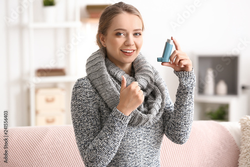 Young woman with inhaler at...