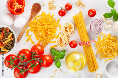 ingredients for italian cousine flat lay, pasta spaghetti penne fusilli tomato oil vegetables