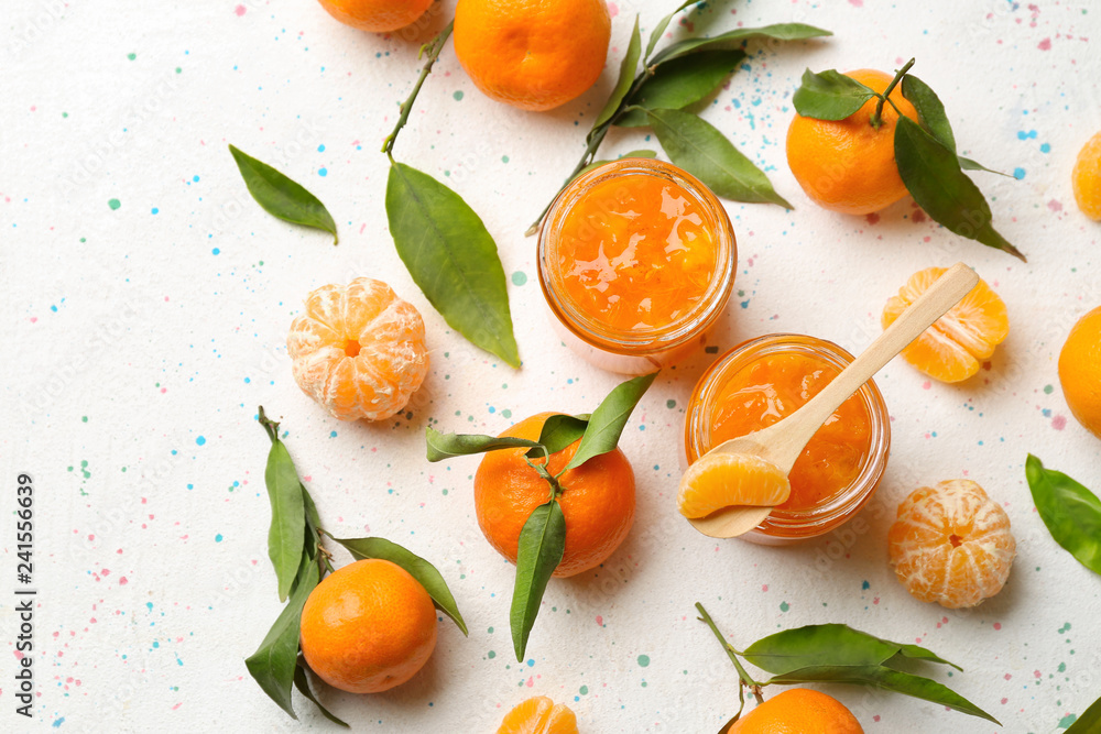 Jars of tasty tangerine jam on light table Jars of tasty tangerine jam on light table
