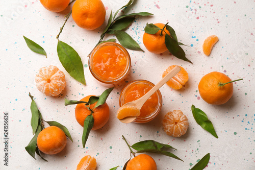 Obraz na plátně Jars of tasty tangerine jam on light table