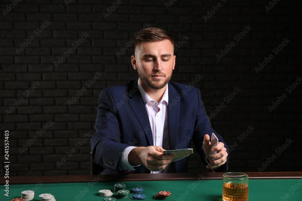 Handsome poker player at table in casino Handsome poker player at table in casino