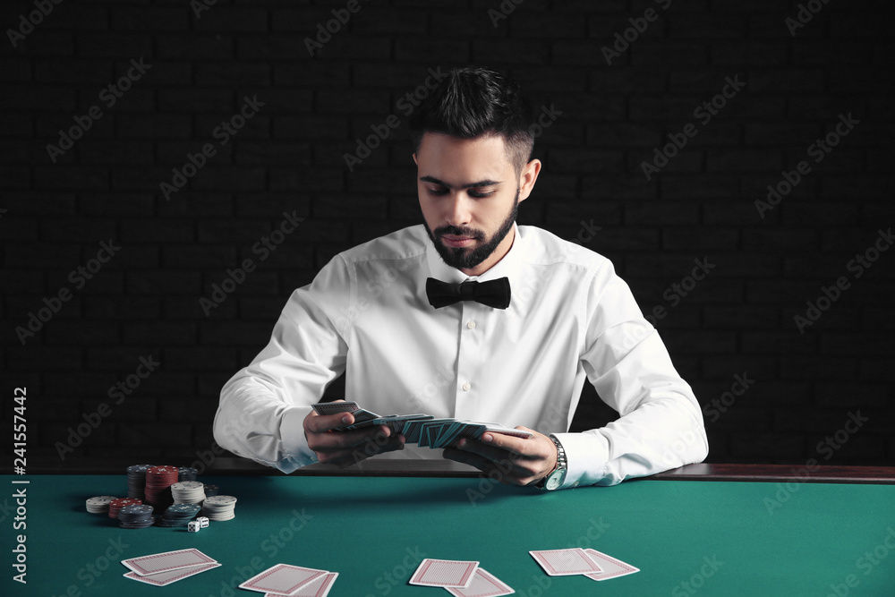 Handsome poker player at table in casino Handsome poker player at table in casino