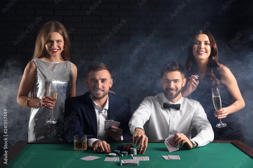 Group of poker players at table in casino Group of poker players at table in casino