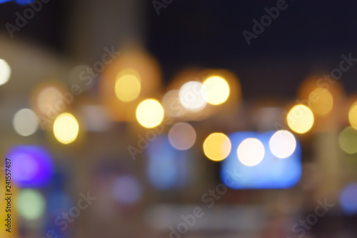 Bokeh from indoor lighting, Colorful light circles spread on blue with yellow and green background for the celebration of the holiday season © anant_kaset