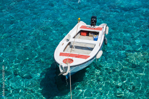 White boat at crystal clear blue water of Marmara beach, near Aradena gorge, island of Crete, Greece