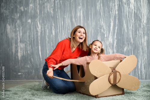 Little girl with mother pla...
