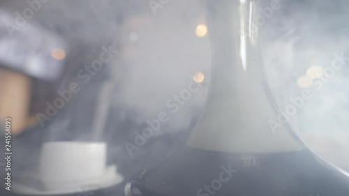 Below shot of a man hookah bulb and tea cup on a table, man spending great day in cafe. photo