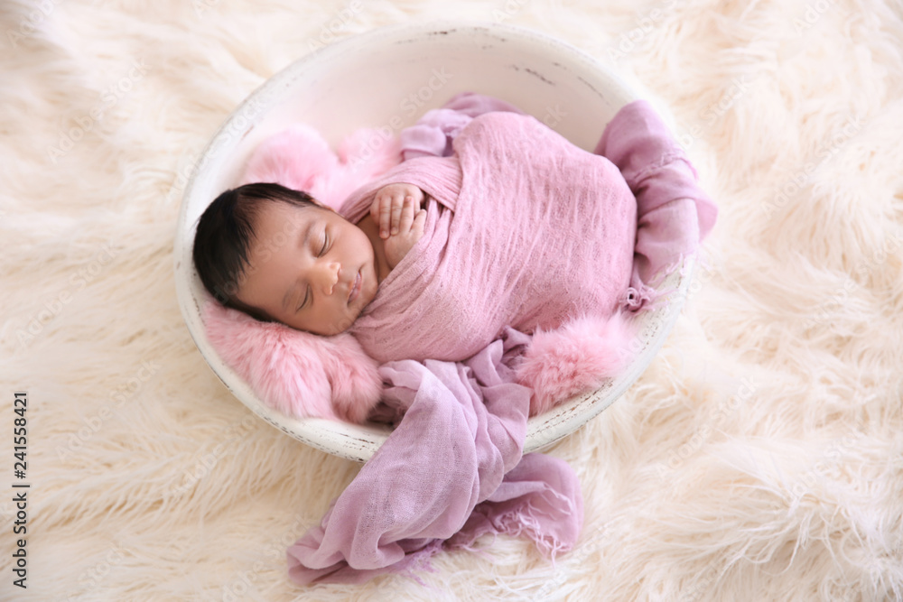 Cute African-American baby on light furry background Cute African-American baby on light furry background