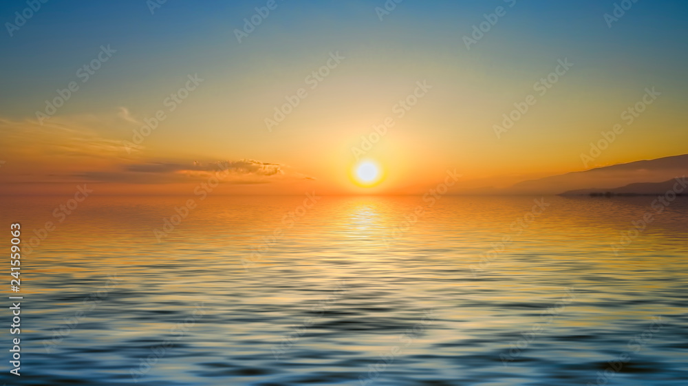 Magnificent bright sunset over the calm surface of the sea.