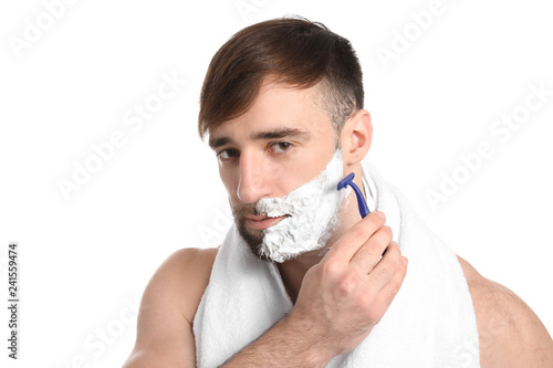 Handsome man shaving agains...