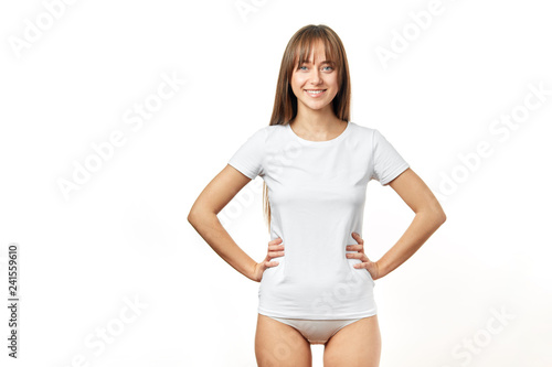 Fit slender long-haired young woman with small waist and perfect skin, dressed in white cotton underwear, smiling at camera isolated on white background. Fitness, Sport, Perfect Woman Body Concept. © alfa27