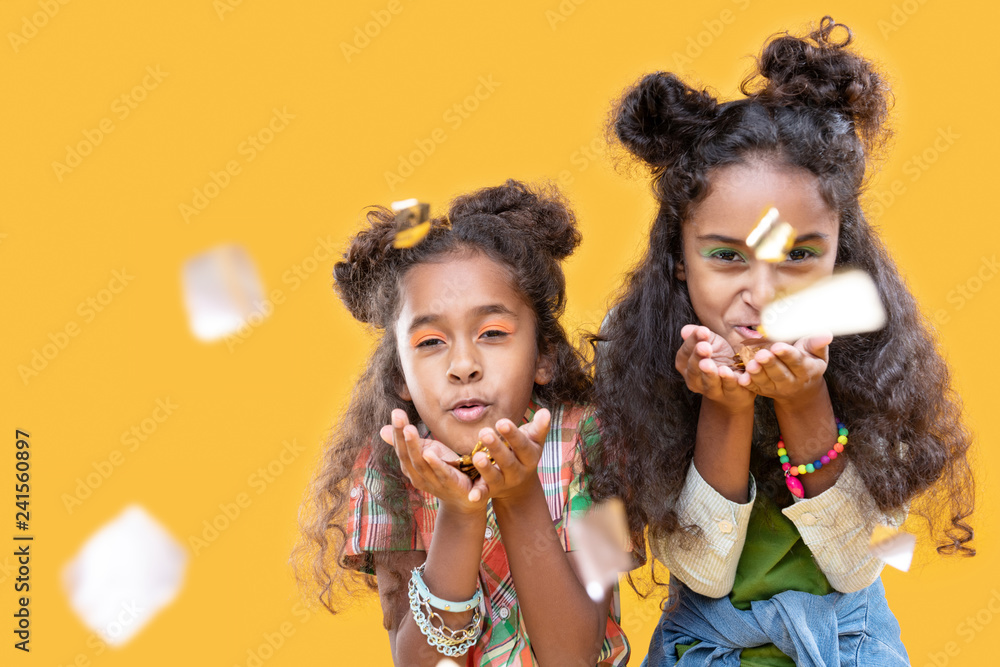 Nice afro American girls blowing foil pieces at you Nice afro American girls blowing foil pieces at you