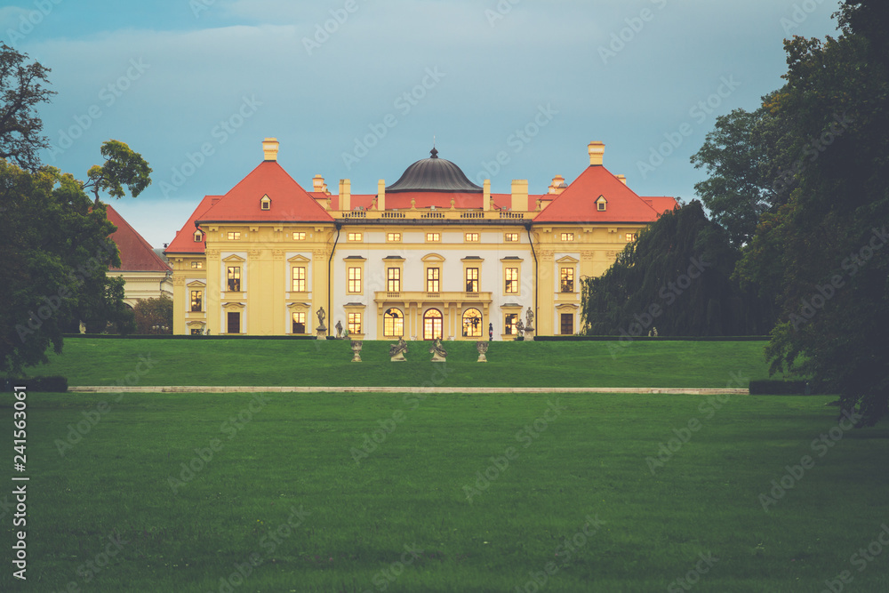 Austerlitz Castle - a stunning baroque palace at twilight with gold sunset reflecting from the windows.  Slavkov u Brna, South Moravia, Czech Republic.