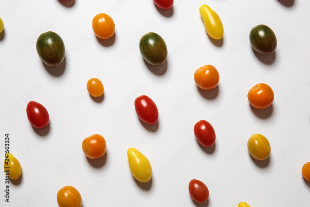 Many colorful tomatoes on white background