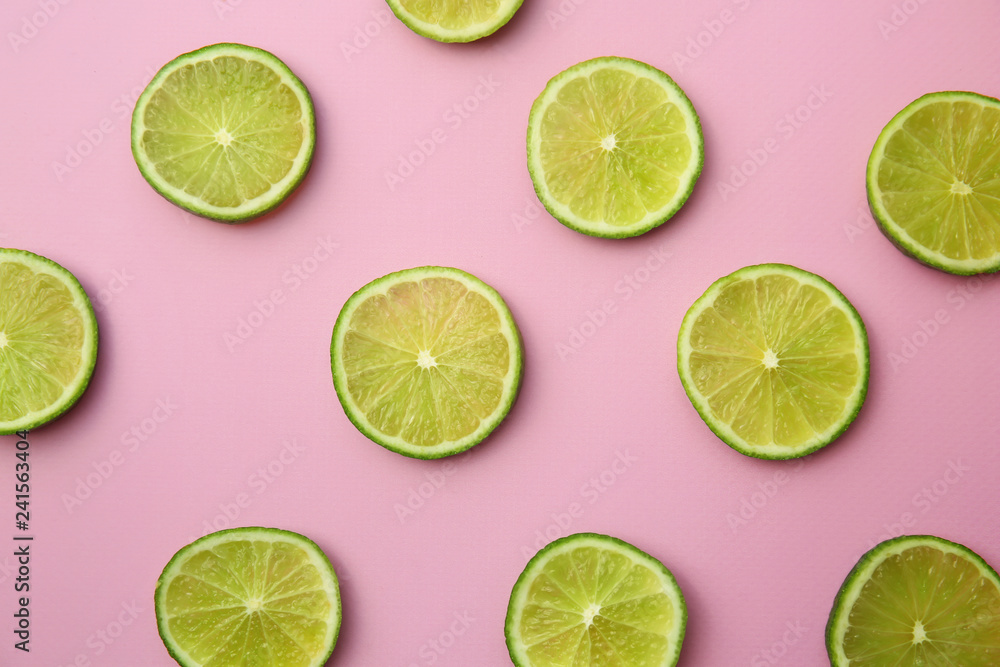 Many slices of lime on color background