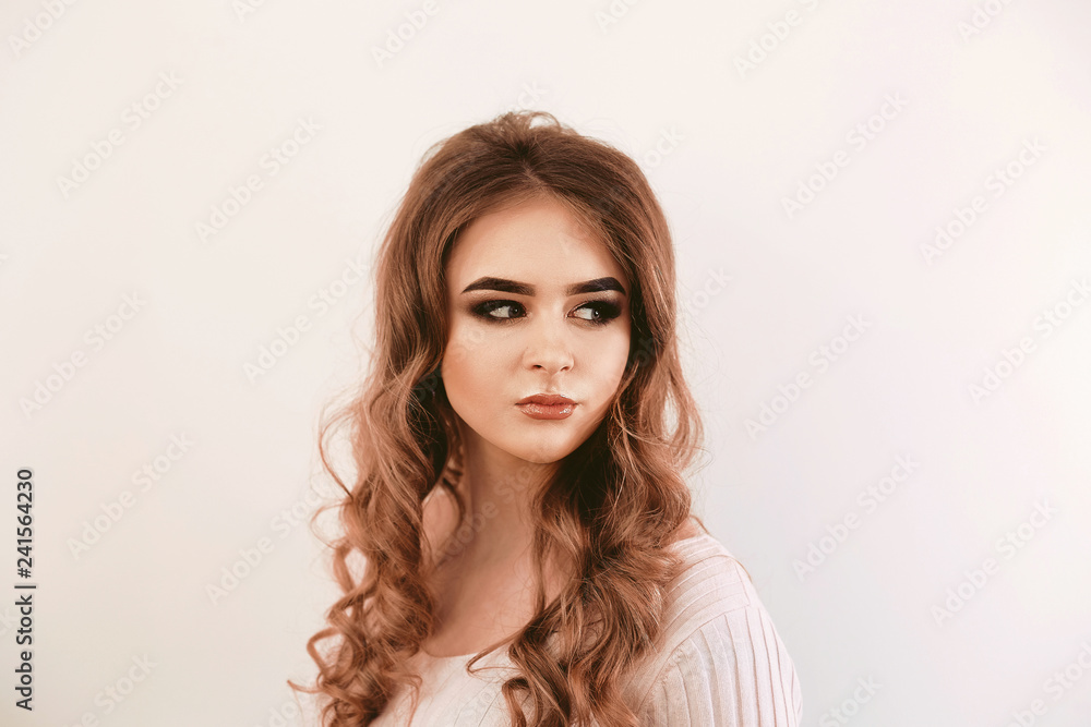 Beautiful girl with long wavy hair . Brunette with curly hairsty Beautiful girl with long wavy hair . Brunette with curly hairsty
