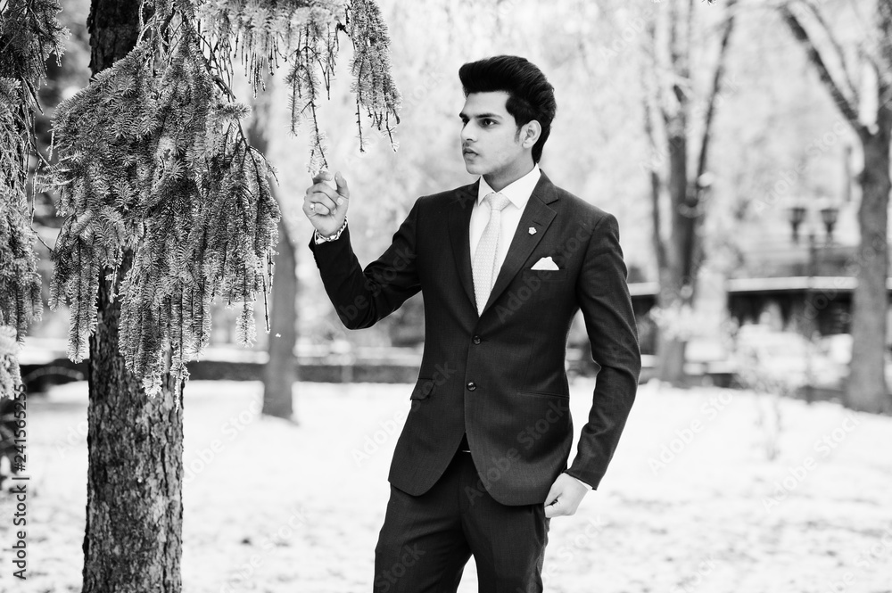Elegant indian macho man model on suit and pink tie posed on winter day. Elegant indian macho man model on suit and pink tie posed on winter day.