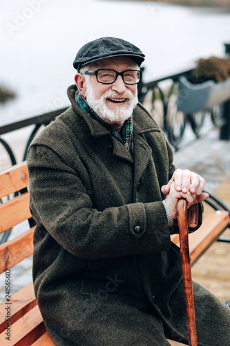 Pleased male person keeping smile on his face photo