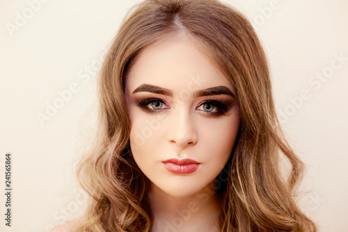 Beautiful model girl with Fashion Luxury Makeup, long eyelashes, perfect skin facial make-up. Beauty Brunette model woman holiday make up close up. Eyelash extensions, false eyelashes. Beauty Woman.