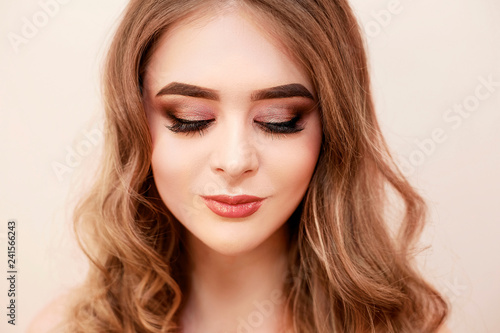 Beautiful model girl with Fashion Luxury Makeup, long eyelashes, perfect skin facial make-up. Beauty Brunette model woman holiday make up close up. Eyelash extensions, false eyelashes. Beauty Woman.