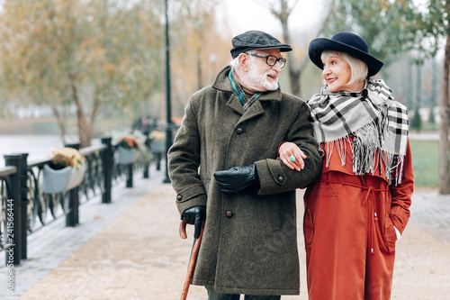 Positive delighted mature people looking at each other