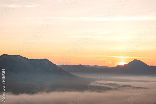 Morning atmosphere at Mueang Loei Chiangkhan with warm tone and mountain range covered with fog © anuruk