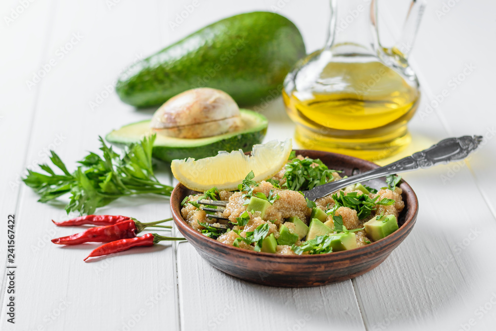 Salad of amaranth seeds, avocado and parsley with olive oil on a table. Salad of amaranth seeds, avocado and parsley with olive oil on a table.