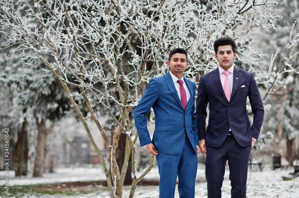 Two elegant indian fashionable mans model on suit posed at winter day. Two elegant indian fashionable mans model on suit posed at winter day.
