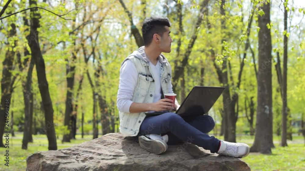 Asian man freelancer working on laptop and drinking coffee Asian man freelancer working on laptop and drinking coffee
