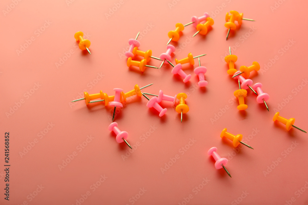 Many pins on coral background Many pins on coral background