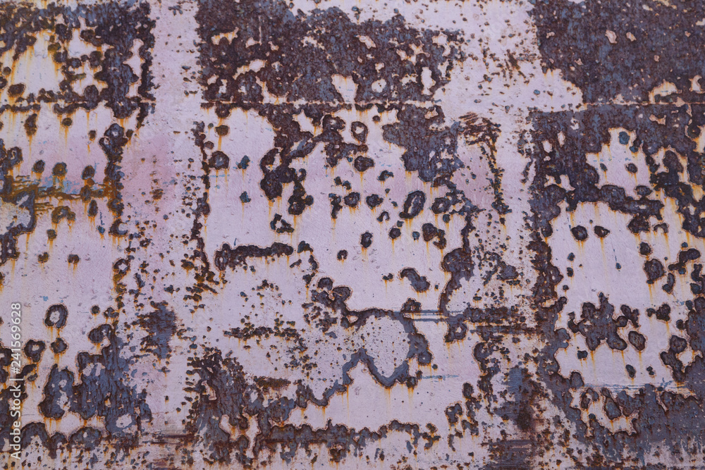 Red painted metal surface with large rust stains as background Red painted metal surface with large rust stains as background