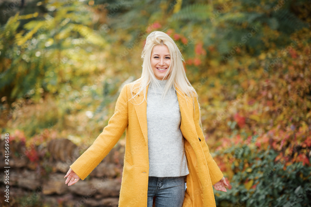 Fashion lifestyle portrait of young happy blond woman laughing and having fun in the city park at nice sunny day. bright fresh colors Fashion lifestyle portrait of young happy blond woman laughing and having fun in the city park at nice sunny day. bright fresh colors