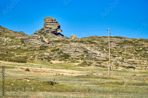 Beautiful panoramic summer steppe landscape of stone mountains 