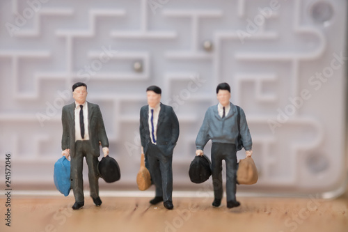 Miniature people: Businessman leave from maze  to the future concept