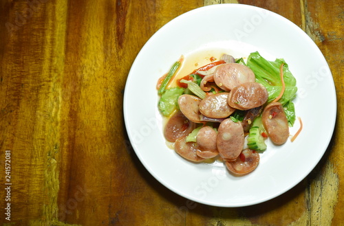 spicy Chinese pork sausage with vegetable Thai salad on plate