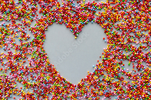 Background of colored balls, with a heart in the center, love concept, for Valentine's Day, mother's day, father's day, Christmas, holidays.